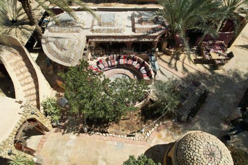 an overhead view of a garden with trees and a building at Panta Lodge Siwa بنتا لودج سيوة in Siwa