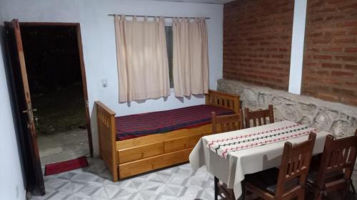 a bedroom with a wooden bed and a window at Fer in La Falda