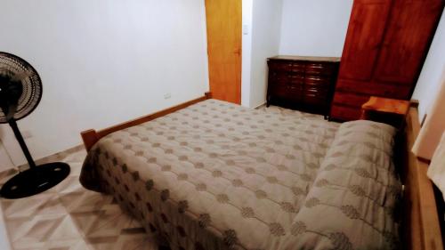 a bedroom with a bed in a room with a fan at Fer in La Falda
