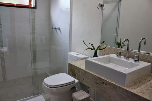 a bathroom with a sink and a toilet and a shower at Ilha Deck Hotel in Ilhabela