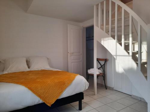 a bedroom with a bed and a staircase at RESIDENCE KER OSMOZ in Saint-Herblain
