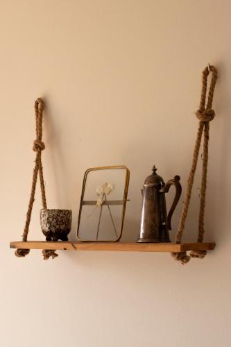 a shelf with a tea kettle on a wall at Hostal de l'Aigua in Sant Llorenç de la Muga