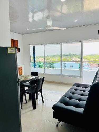 a living room with a couch and a table at TORRES DEL MESÓN LUXURY APARTMENTS Doradal in Doradal