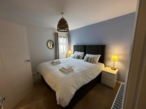 a bedroom with a bed with two towels on it at 1 Island View in Portrush