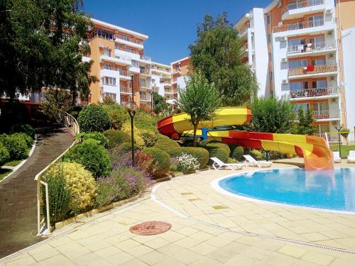 una piscina con tobogán en un complejo de apartamentos en Family Apartament Crown Pool&Sea - BastetBS, en Sveti Vlas