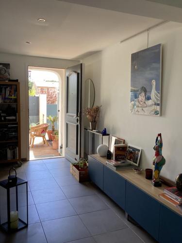 uma sala de estar com um armário azul e vista para um pátio em Chambre Le Crès em Le Crès