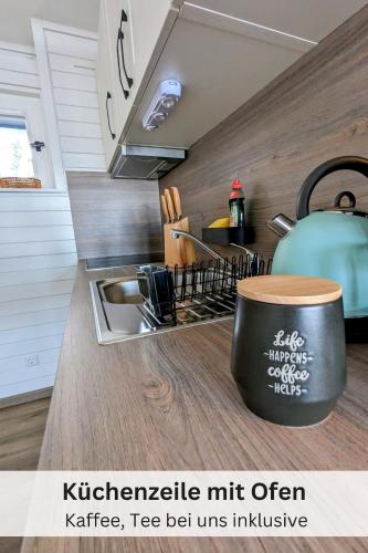 a kitchen with a sink and a counter top at Black Forest Stay - Apartment Hirschperle in Sasbachwalden