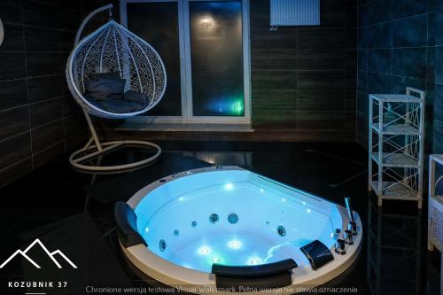 a bath tub in a room with a window at Kozubnik 37 in Porąbka