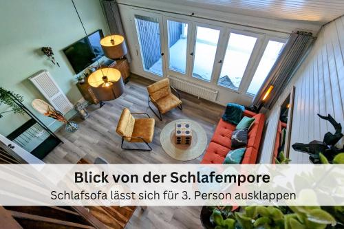 a view of a living room with a couch and chairs at Black Forest Stay - Apartment Hirschperle in Sasbachwalden