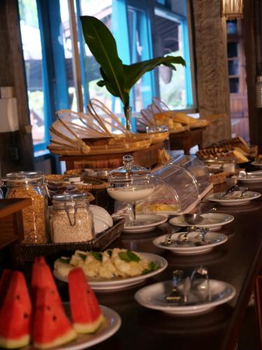 a buffet with plates of food on a table at Ilha Deck Hotel in Ilhabela