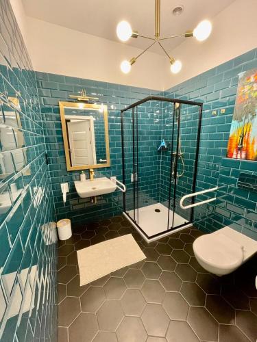 a bathroom with a shower and a toilet and a sink at Apartamenty Green in Stargard