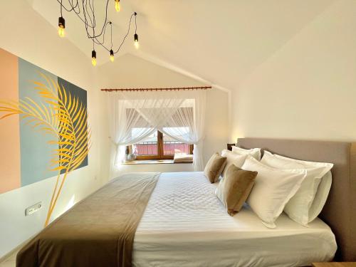 a bedroom with a large bed with white pillows at Villa Serenity Budva in Budva