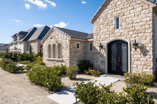 a brick house with a black door at Domaine Chardonnay in Temecula