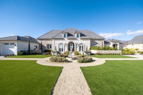 a large house with a green lawn at Domaine Chardonnay in Temecula