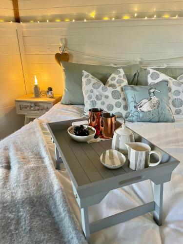 a bed with a tray of food on a table at South Barlogan Farm in Bridge of Weir