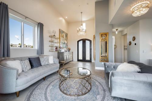 a living room with two couches and a table at Domaine Chardonnay in Temecula
