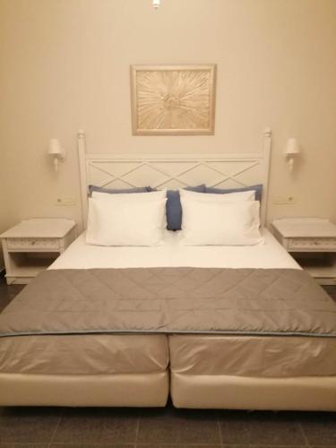 a bedroom with a large bed with two night stands at Manolis&Xenia in Kefalos