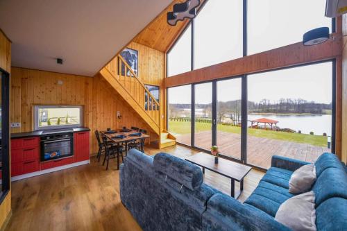 a living room with a blue couch and a table at Nini House Swietajno in Olecko