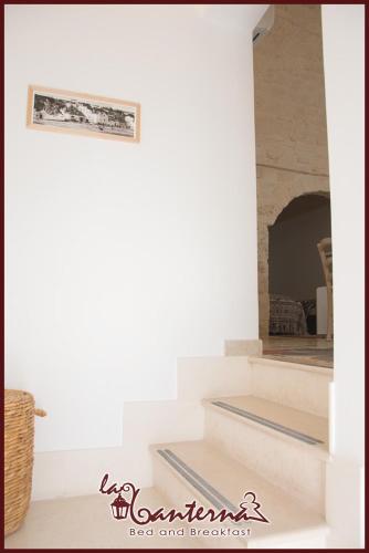 a staircase in a house with a mirror at "B&B La Lanterna" Trulli & Dimore Storiche in Alberobello