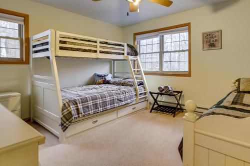 a bedroom with a bunk bed with a ladder at Hot Tub and Game Room Cozy Big Bass Lake Home! in Gouldsboro