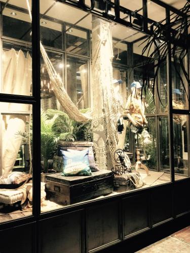 a display window of a store with furniture and plants at M Boutique Hotel Station 18 - Ipoh in Ipoh
