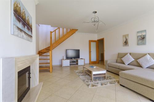 a living room with a couch and a fireplace at Alojamento Santo António in Peniche