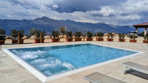 a swimming pool with mountains in the background at Agriturismo La Part in San Zeno di Montagna