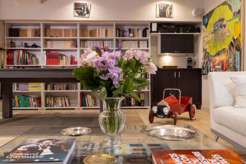 a living room with a vase of flowers on a table at Maison Lavaud in Paris