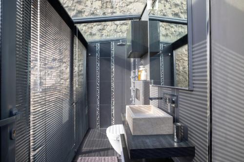 a bathroom with a sink and a large window at Maison Lavaud in Paris