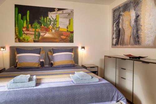 a bedroom with a bed with towels on it at Maison Lavaud in Paris