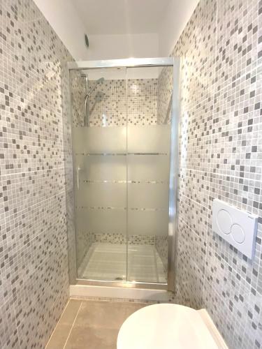 a bathroom with a glass shower with a toilet at La Stella Marinella in Santa Marinella