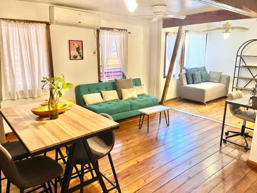 a living room with a green couch and a table at Seabreeze Inn in West End