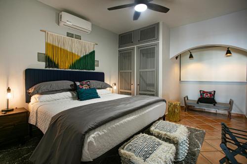 a bedroom with a large bed and a chair at Villa Cobojo in Bucerías