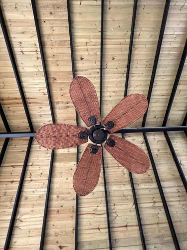 a ceiling fan in a room with a brown at La Manola Finca Hotel in Doradal