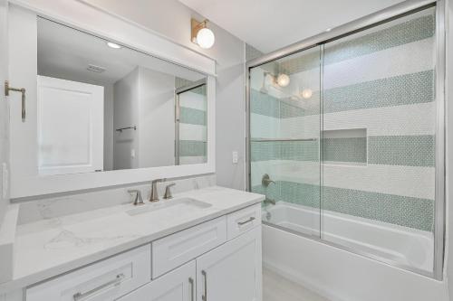 a white bathroom with a sink and a shower at La Joya Azul in Inlet Beach