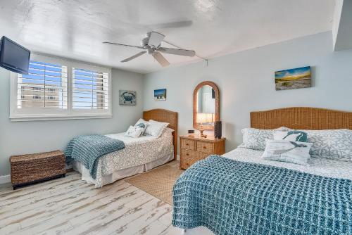 a bedroom with two beds and a ceiling fan at Bob's Beachin Dream - 5040S in Port Orange