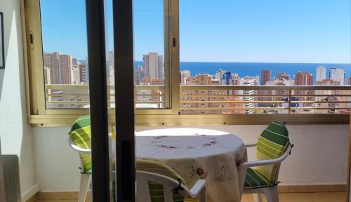 a table and chairs in a room with a window at PANORAMIC VIEW in Benidorm