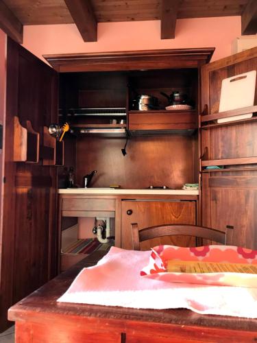 a kitchen with wooden cabinets and a table in it at Agriturismo Alla Casella in Ferrara