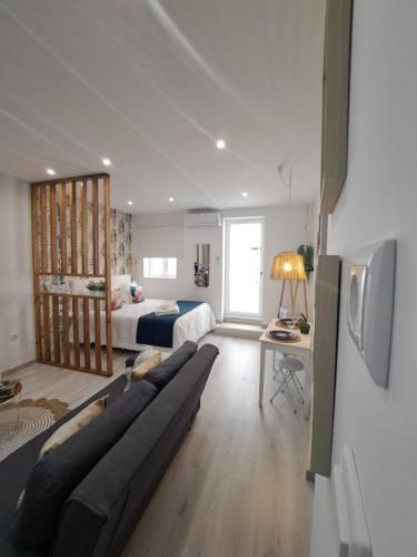 a living room with a couch and a bed at Lucas House in Nazaré