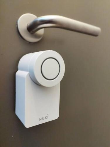 a white soap dispenser on a wall at Au pied du mur in Huy