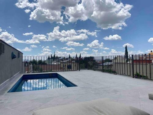 a swimming pool on a patio with a fence at AMAZING HOME WITH POOL IN A STELLAR LOCATION in San Miguel de Allende
