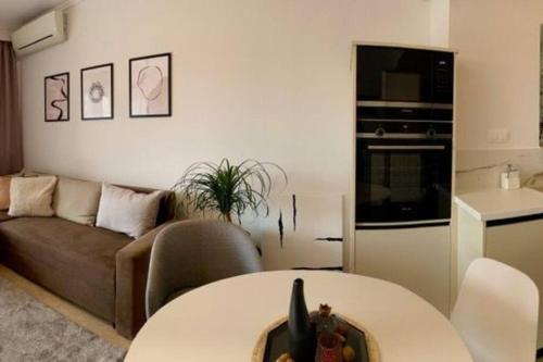 a living room with a couch and a table at East Coast Senses in Thessaloniki
