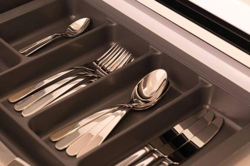 a tray with silver utensils in a drawer at East Coast Senses in Thessaloniki