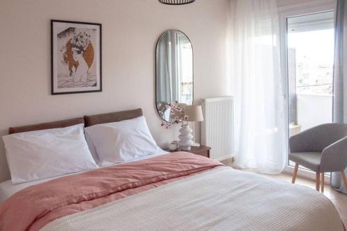 a bedroom with a bed and a chair and a mirror at East Coast Senses in Thessaloniki