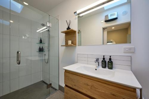 a bathroom with a sink and a shower at Shearwater Apartments in Kaikoura
