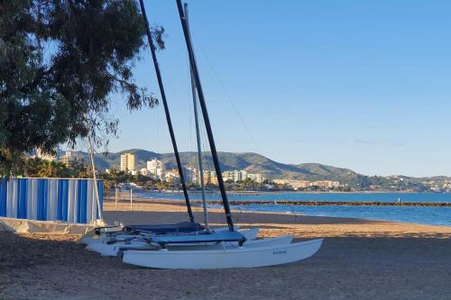 a group of boats sitting on the beach at Incredible seafront with sunrise and sunset views in Benicàssim