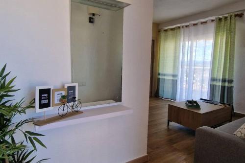 a living room with a couch and a table at Incredible seafront with sunrise and sunset views in Benicàssim