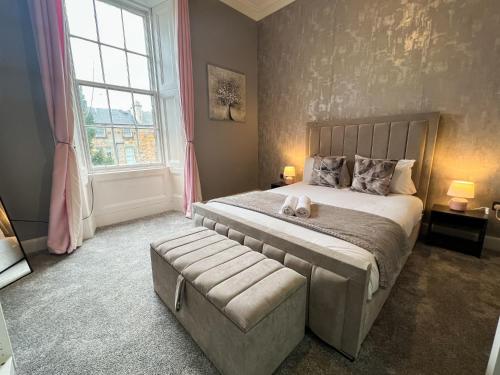 a bedroom with a large bed and a large window at Premium 2BR Flat in the City Centre in Glasgow