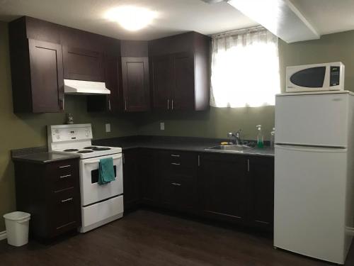 a kitchen with a white stove and a white refrigerator at Private Rooms Male Accommodation Close to NAIT Kingsway Mall Downtown in Edmonton