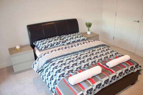 a bedroom with a bed with two baseball bats on it at Apartment in the heart of london Greenford in Perivale